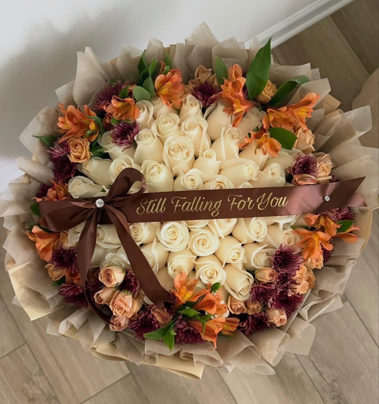 Still Falling For You fall bouquet — cream roses with orange and burgundy blooms