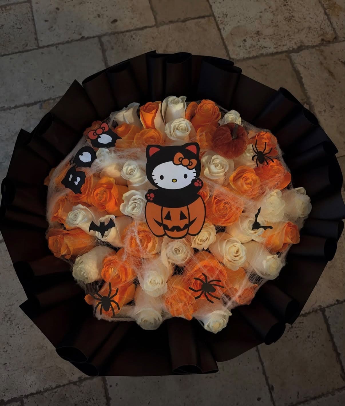 Halloween bouquet of orange and white roses with a pumpkin Hello Kitty and bats